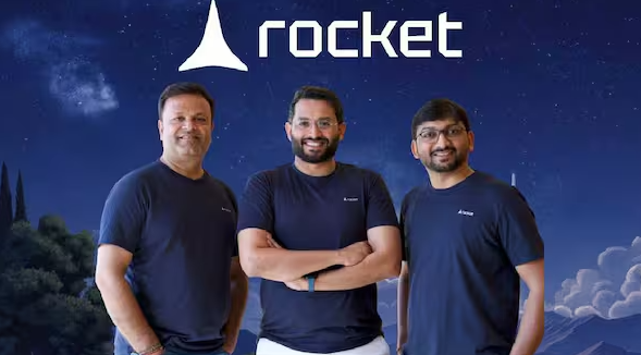 Rocket AI Startup founders stand beneath the company logo as the Surat-based AI startup seeks $50 million in Series A funding at a $500 million valuation.
