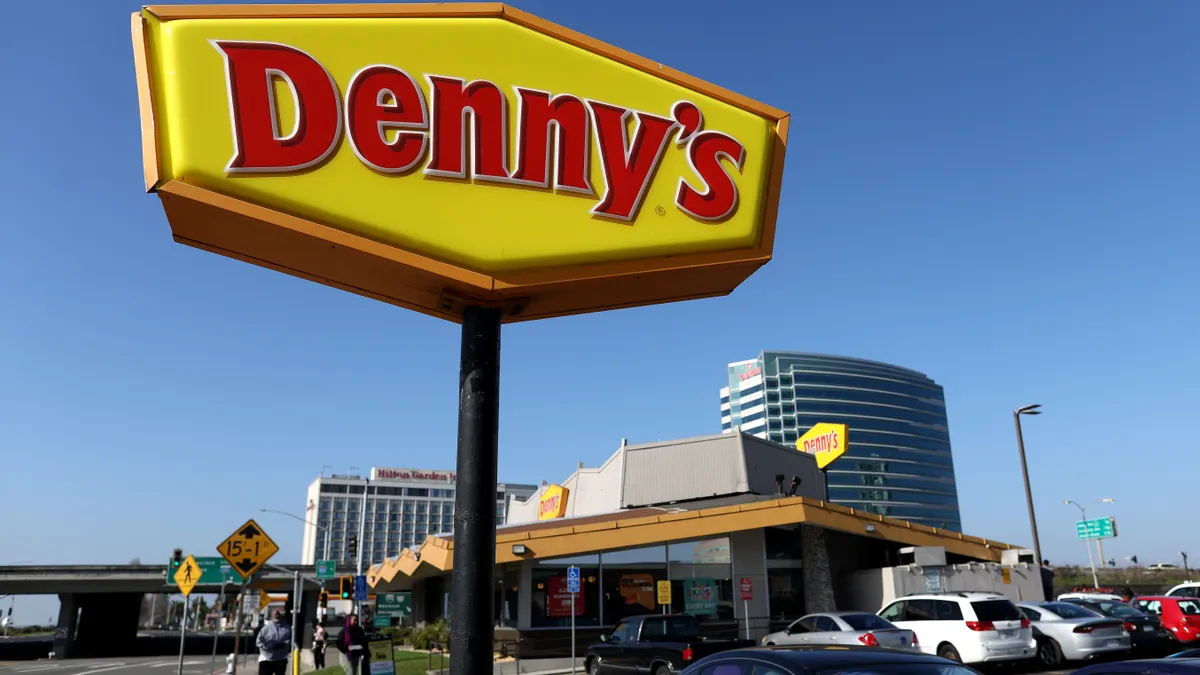 Denny's store closures 2026 - Denny's restaurant sign and building with parking lot amid franchisee bankruptcy