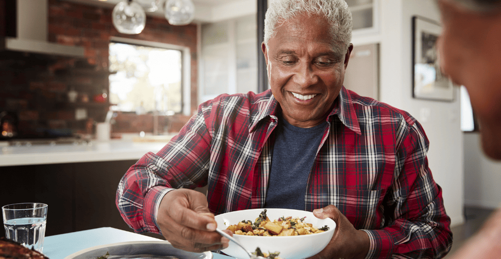 Older adult eating a protein-rich meal to support muscle health, strength, and healthy aging with balanced nutrition.