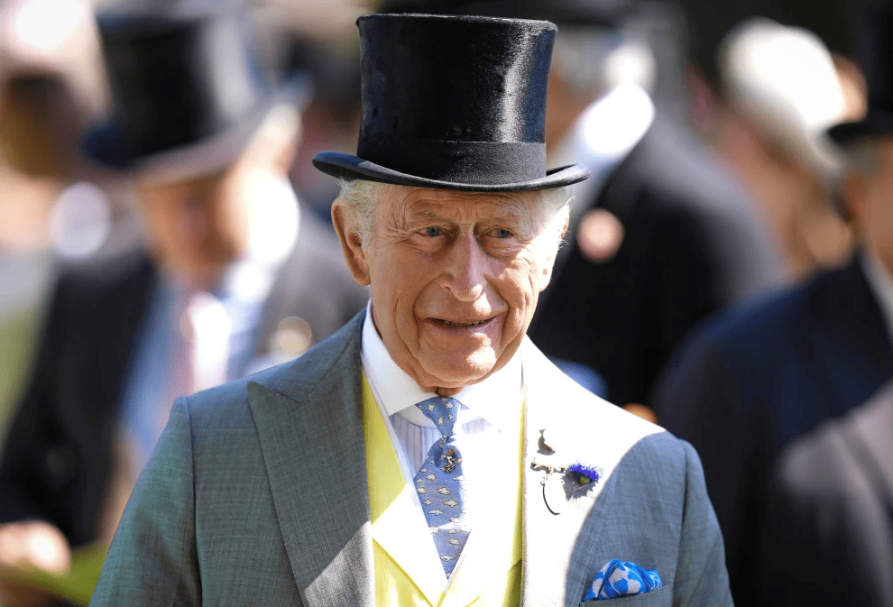 King Charles III wearing a top hat and formal morning suit during a royal event after disclosing his £12.9 million tax bill.