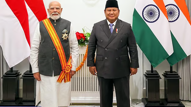 Prime Minister Narendra Modi wearing the Bintang Adipurna sash alongside Indonesian President Prabowo Subianto after receiving Indonesia's highest civilian award in Jakarta.