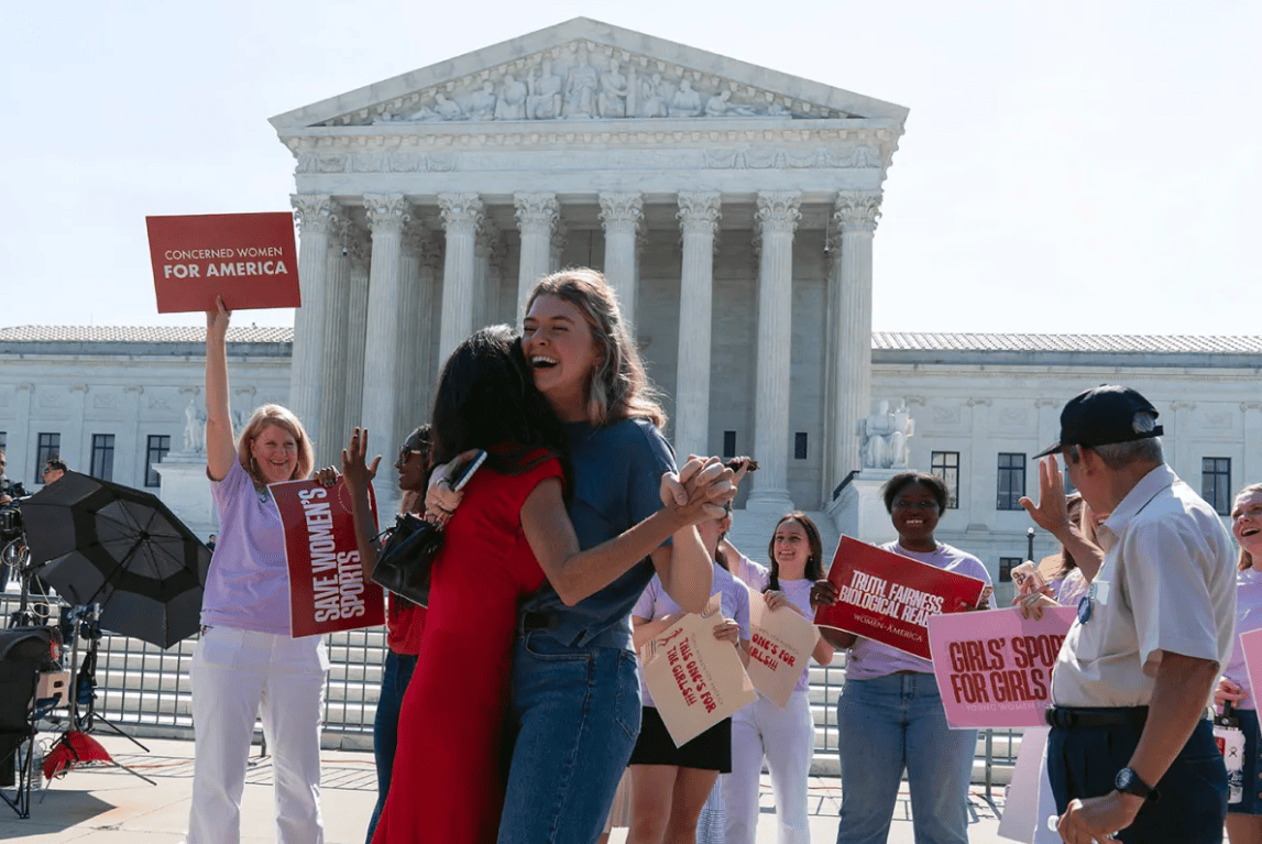 Supporters celebrate outside the U.S. Supreme Court following a ruling upholding state bans on transgender girls competing in girls' school sports.